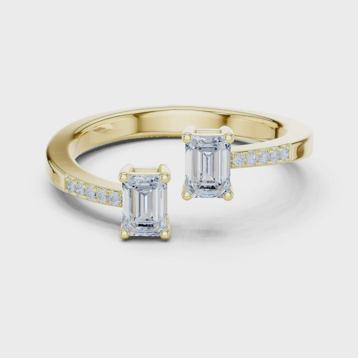 Video of yellow gold two stone ring highlighting double emerald setting and pavé band