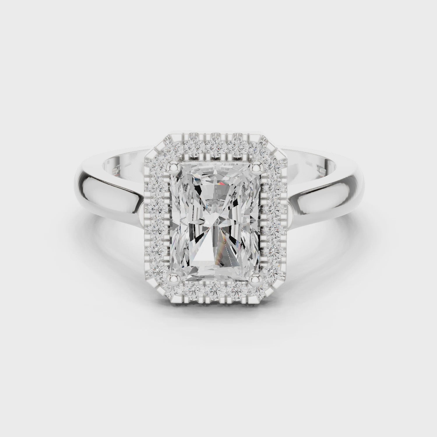Video of white gold radiant halo ring highlighting diamond setting and band profile