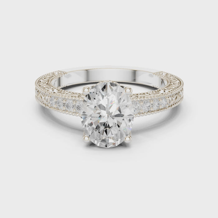 Side view of oval vintage filigree white gold ring with milgrain detailing and channel-set diamond band in video