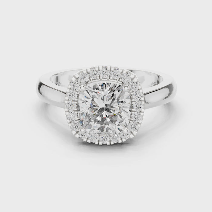 Video of white gold cushion halo ring highlighting diamond setting and band profile