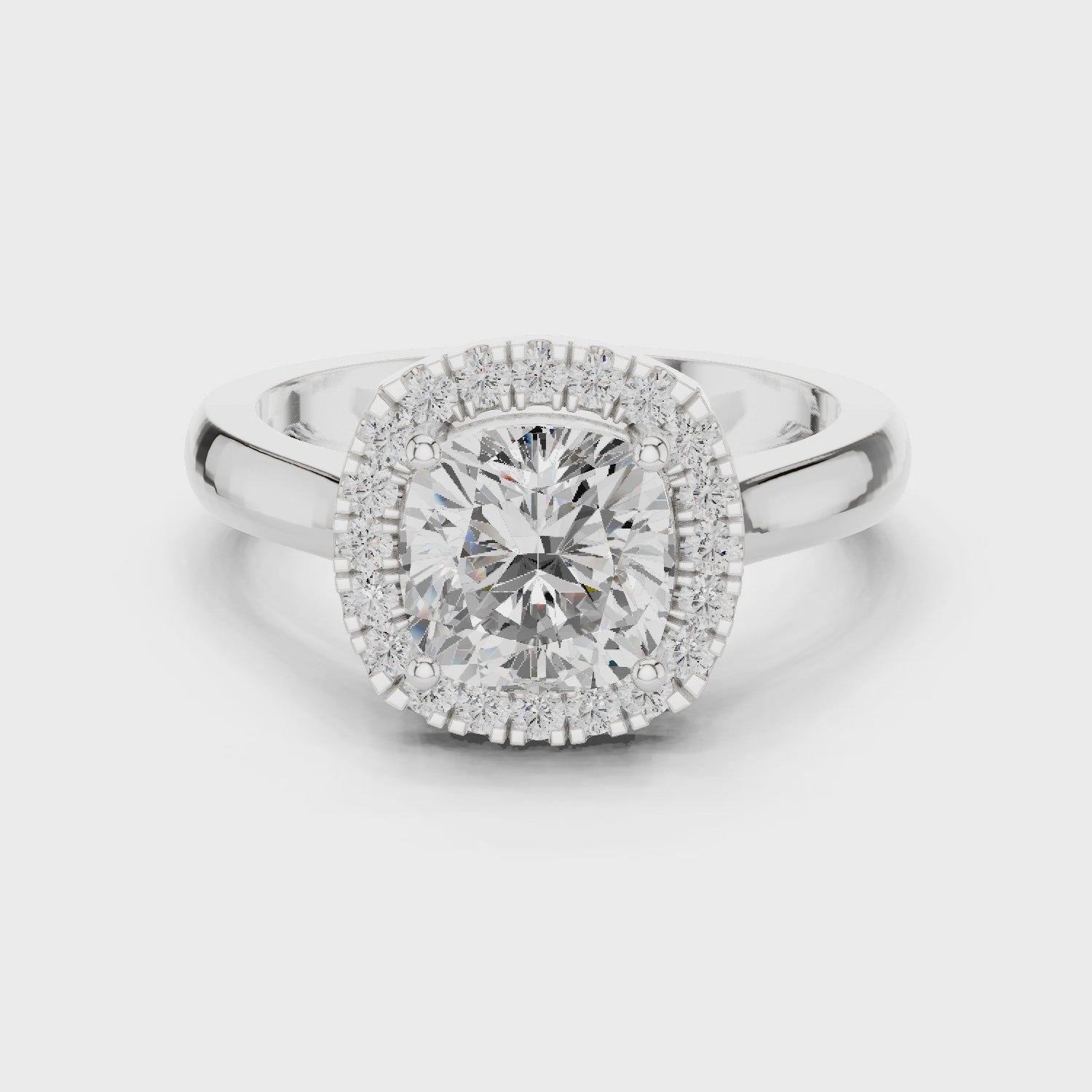 Video of white gold cushion halo ring highlighting diamond setting and band profile