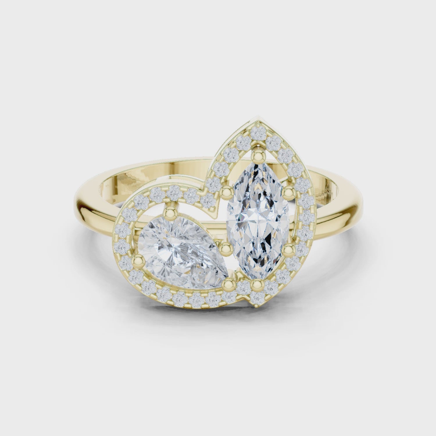 Video of yellow gold Toi et Moi ring highlighting marquise and pear diamonds with halo and split shank