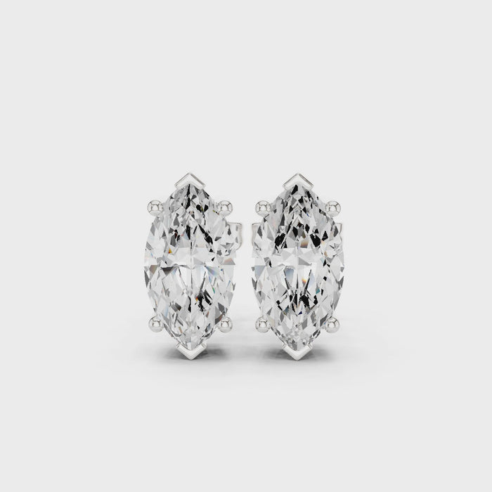 Video of Silver stud earring with a clear gemstone on a white background in white gold with side view