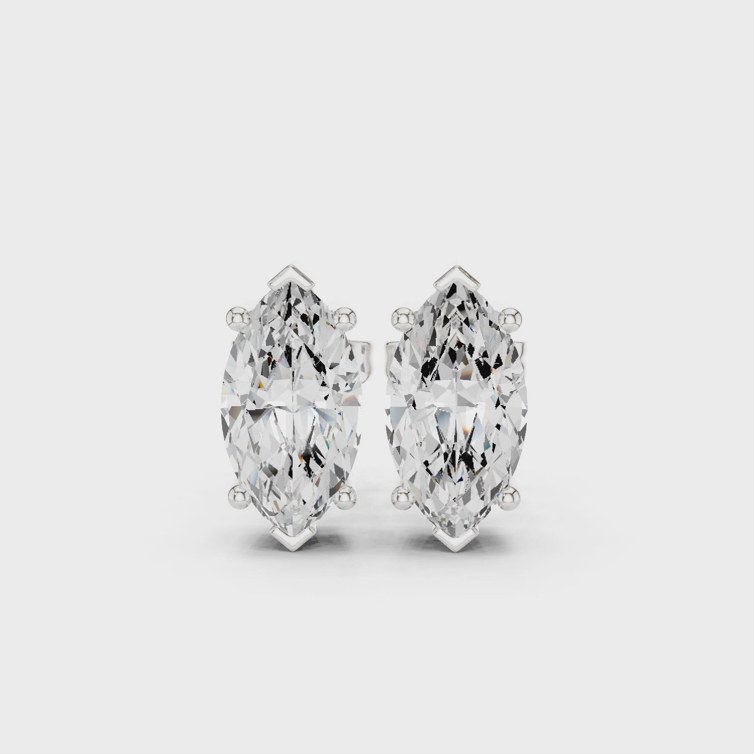 Video of Silver stud earring with a clear gemstone on a white background in white gold with side view