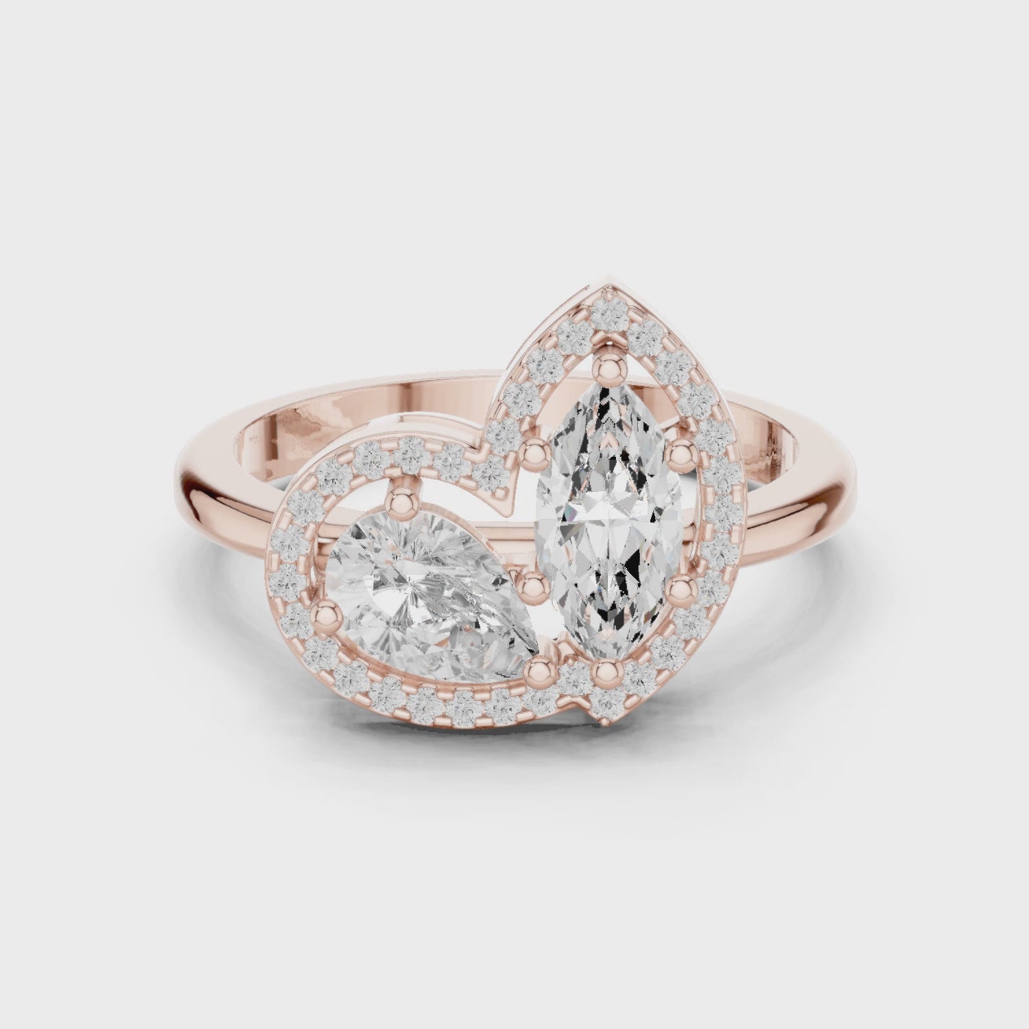 Video of rose gold Toi et Moi ring highlighting marquise and pear diamonds with pavé halo and split shank
