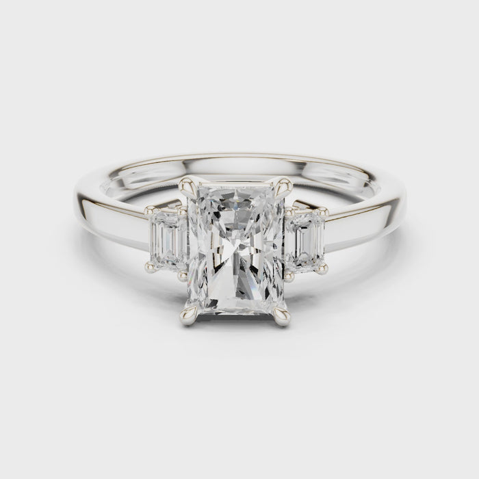 Radiant three stone engagement ring with emerald cut side stones in white gold, lab grown diamond, video, Australia DFE